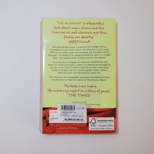 The Alchemist by Paulo Coelho - The Paperhound Online Bookshop. Secondhand books for sale online in South Africa. The back cover of the book features praise and a summary. The cover is predominantly yellow with a red colored bottom edge. At the top, there's a quote from Madonna praising the book as a beautiful exploration of dreams and treasures. Following this, there is a brief synopsis, describing the storyline about a shepherd named Santiago in search of a treasure near the pyramids in Egypt. Insights into the themes of listening to one's heart and following dreams are mentioned. A quote from The Times highlights the book's significant impact on readers. - - The Paperhound Online Bookshop. Secondhand books for sale online in South Africa.
